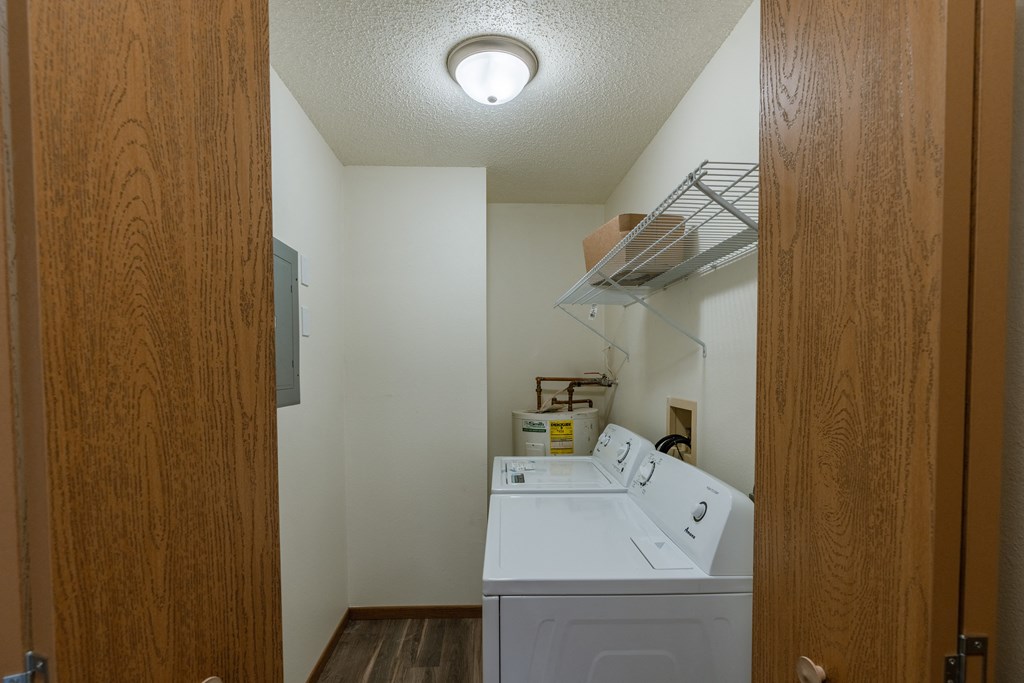 Grand Forks, ND Richfield Apartments. A laundry room with a washer and dryer in it
