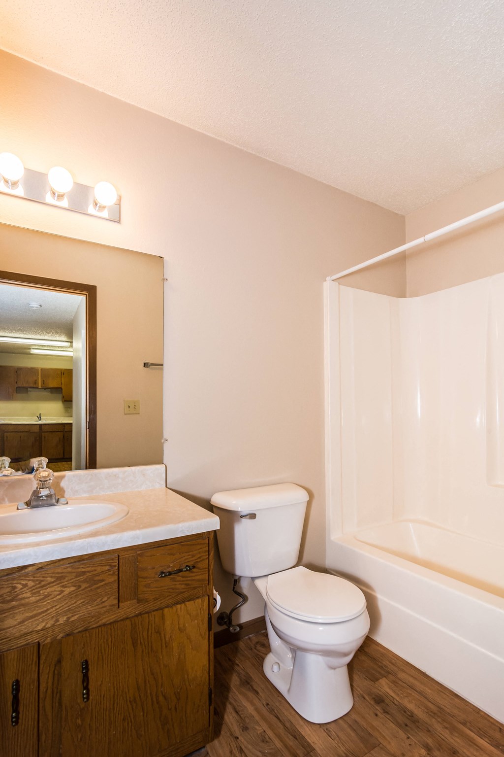 Grand Forks Ridgemont Apartments. A bathroom with a sink, toilet, and bathtub