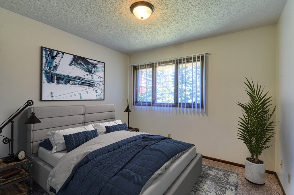 Grand Forks, ND Roughrider Apartments | Bedroom Grand Forks, ND Roughrider Apartments. a bedroom with a large bed and two windows