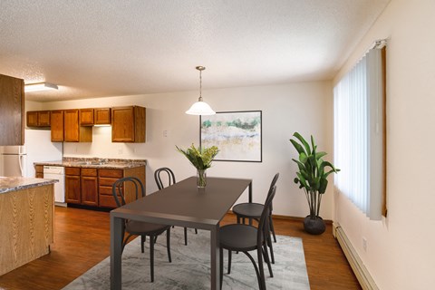 Grand Forks, ND Southview Apartments | Dining A dining room and kitchen with a table and chairs. Grand Forks, ND Southview Apartments.