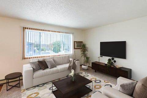 the living room of an apartment with a white couch and a television