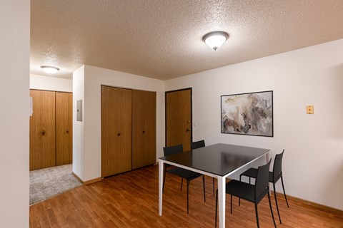 Grand Forks, ND Southview Apartments | Dining A dining room with a table and chairs and a painting on the wall. Grand Forks, ND Southview Apartments.