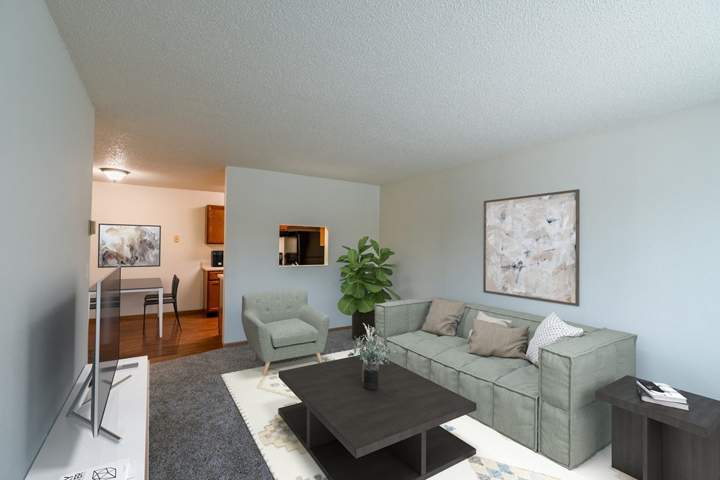 An open living room with a couch and a coffee table. Grand Forks, ND Southview Apartments.