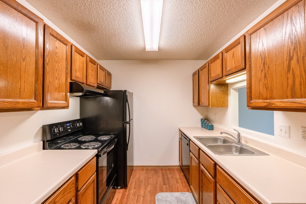 Grand Forks, ND Southview Apartments. A kitchen with black appliances.