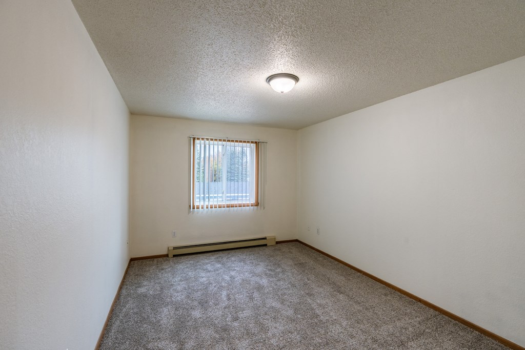 Grand Forks, ND Southview Apartments.  A bedroom with white walls and a window.