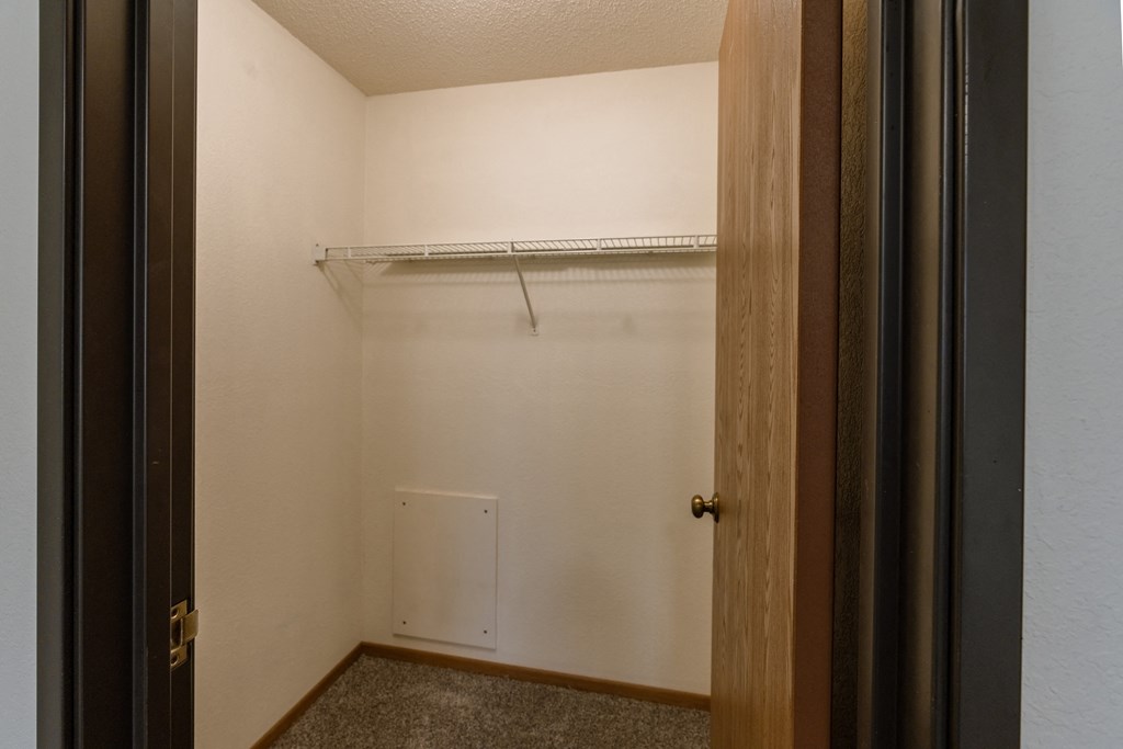 Grand Forks, ND Southview Apartments. A walk in closet with shelves.
