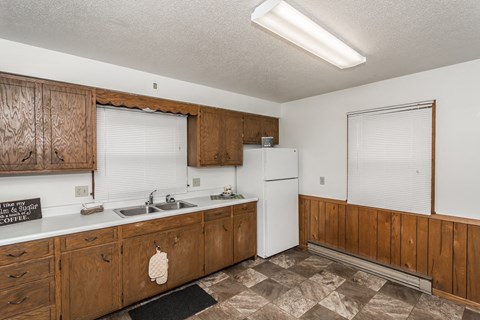 a kitchen with white appliances and wooden cabinets
