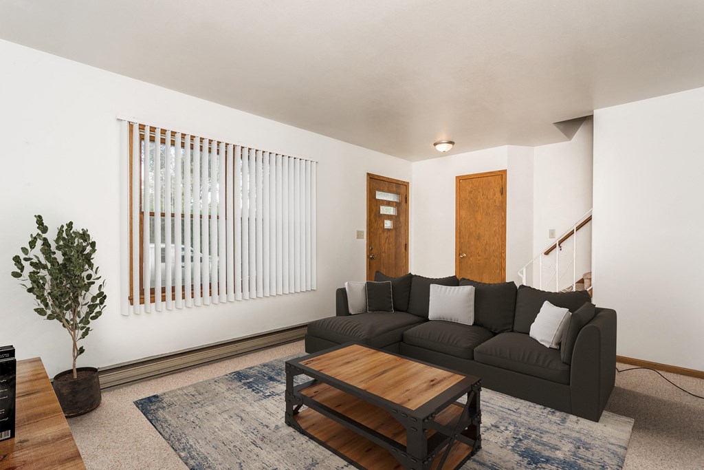 Grand Forks, ND Valley Home Duplex.  a living room with a black couch and a wooden coffee table