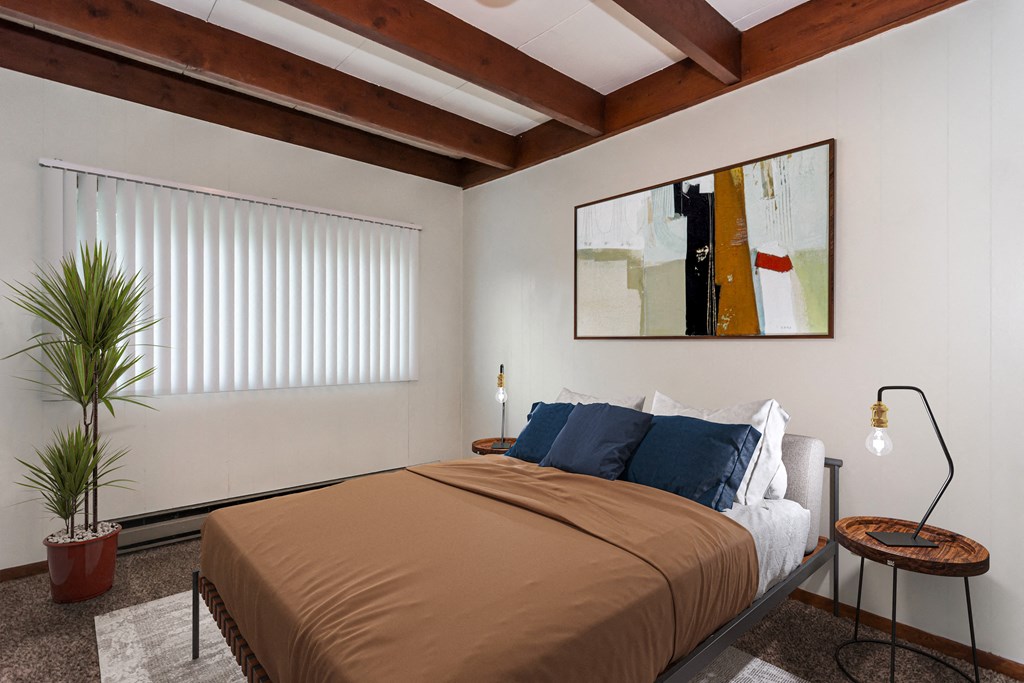 Grand Forks, ND Washington Apartments. a bedroom with a bed and a large painting on the wall