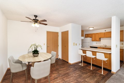 a dining room with a table and chairs and a kitchen