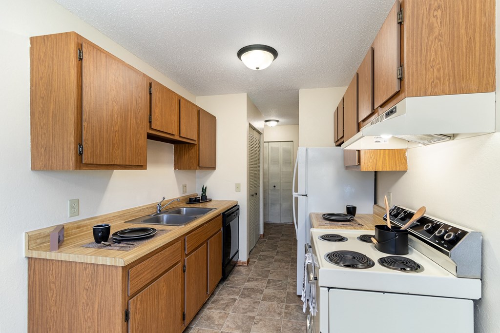 Hutchinson, MN Echo Manor Apartments | 21A | Kitchen a kitchen with a stove and a sink and a refrigerator. Hutchinson, MN Echo Manor Apartments
