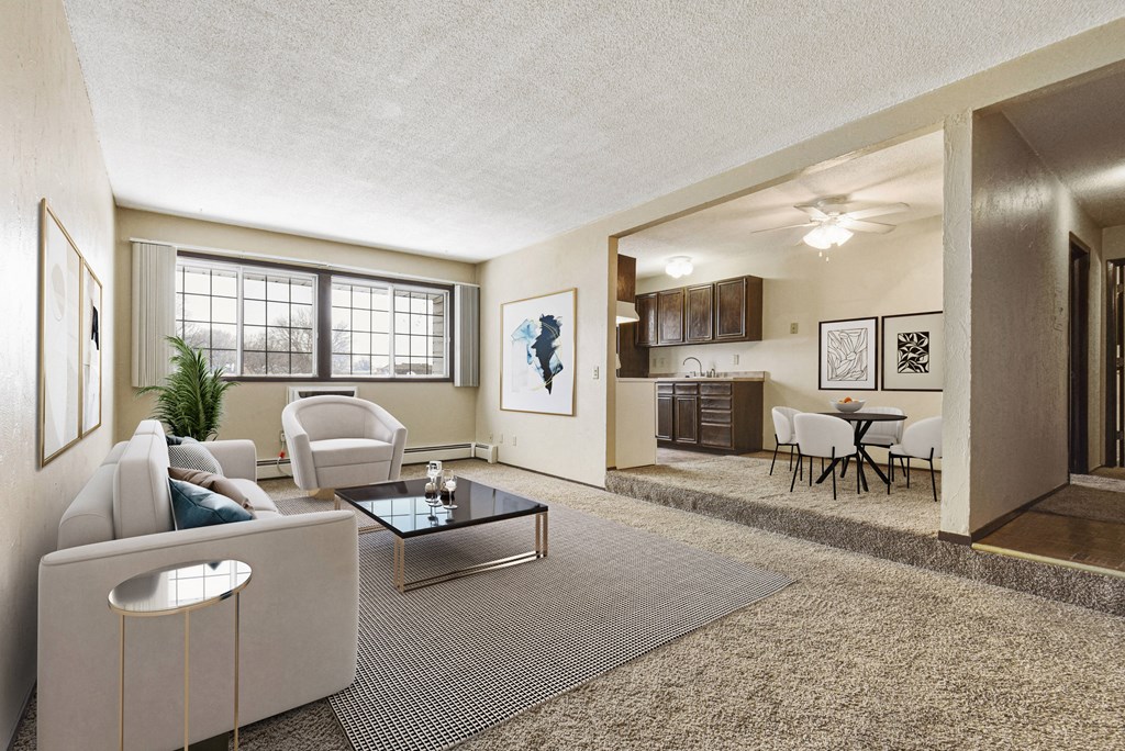 Georgetown on the River Apartments, Fridley, MN, 55432 a living room with a couch table and chairs and a kitchen in the background