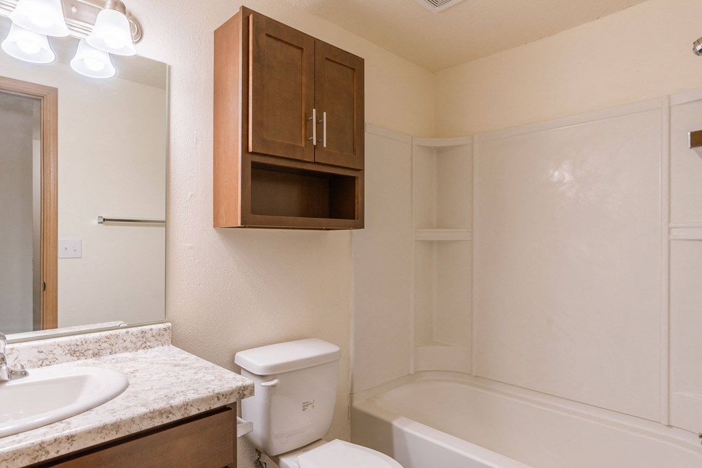 a bathroom with a sink toilet and a bath tub. Moorhead, MN South Park Apartments
