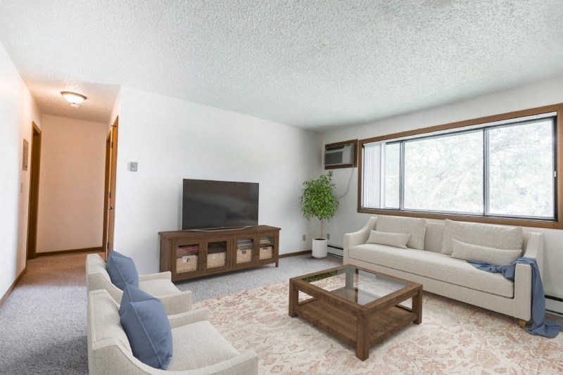 a living room filled with furniture and a flat screen tv