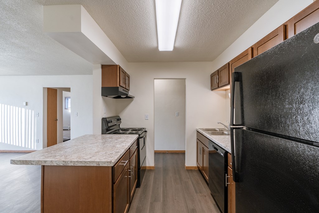 a kitchen and living room. Fargo, ND North Manor Apartments