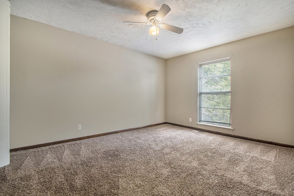 Omaha, NE Beacon Hill Apartments. An empty room with a ceiling fan and a window