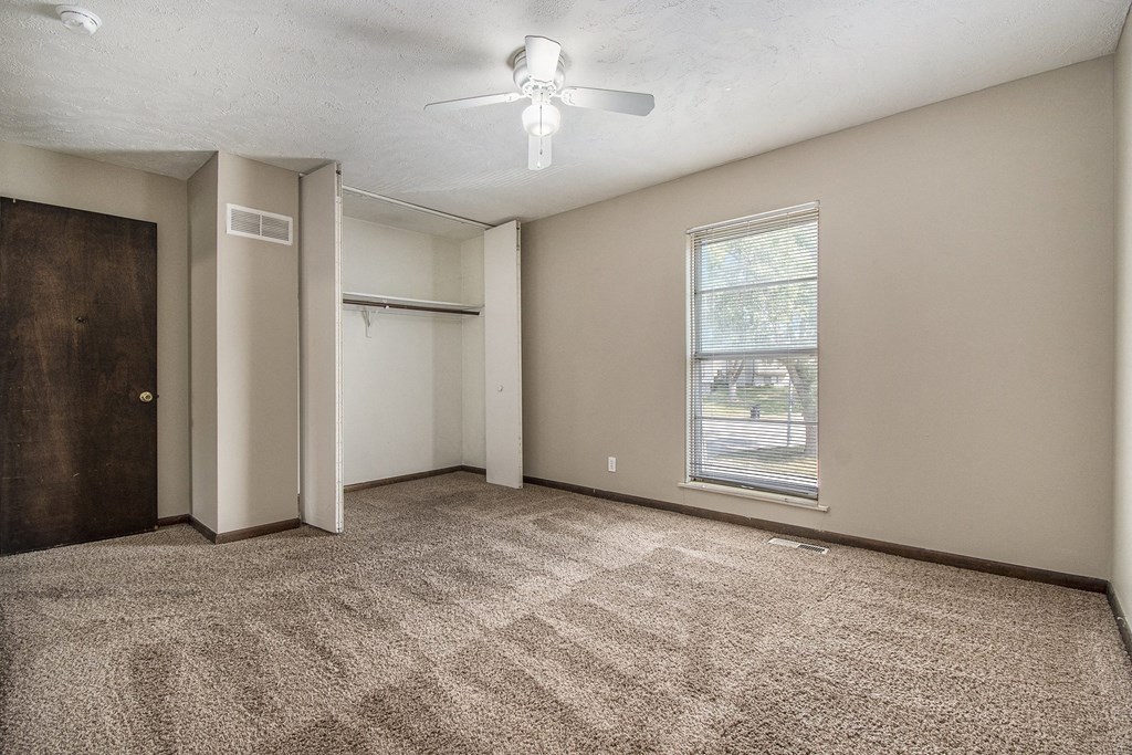 Omaha, NE Beacon Hill Apartments. A bedroom with a ceiling fan and a window