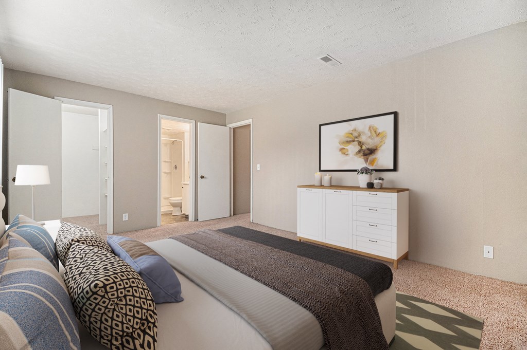 Omaha, NE Evergreen Terrace Apartments. A bedroom with a bed and a dresser