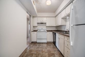 Omaha, NE Evergreen Terrace Apartments | Kitchen Omaha, NE Evergreen Terrace Apartments. A kitchen with white cabinets and white appliances