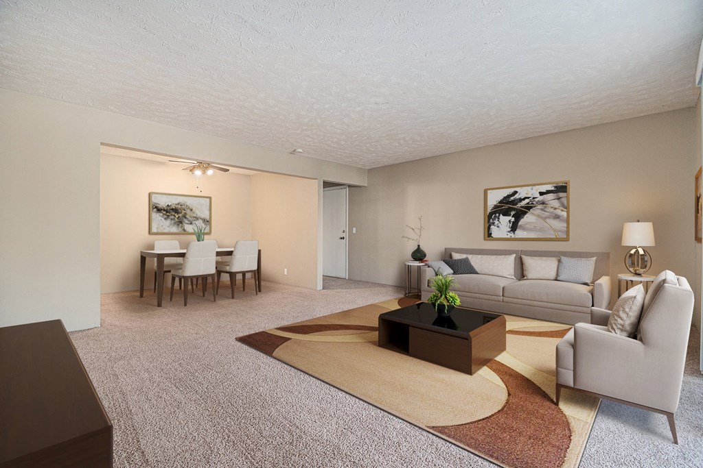 Omaha, NE Evergreen Terrace Apartments. A living room with a couch a table and a chair