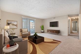 Omaha, NE Evergreen Terrace Apartments. A living room filled with furniture and a flat screen tv