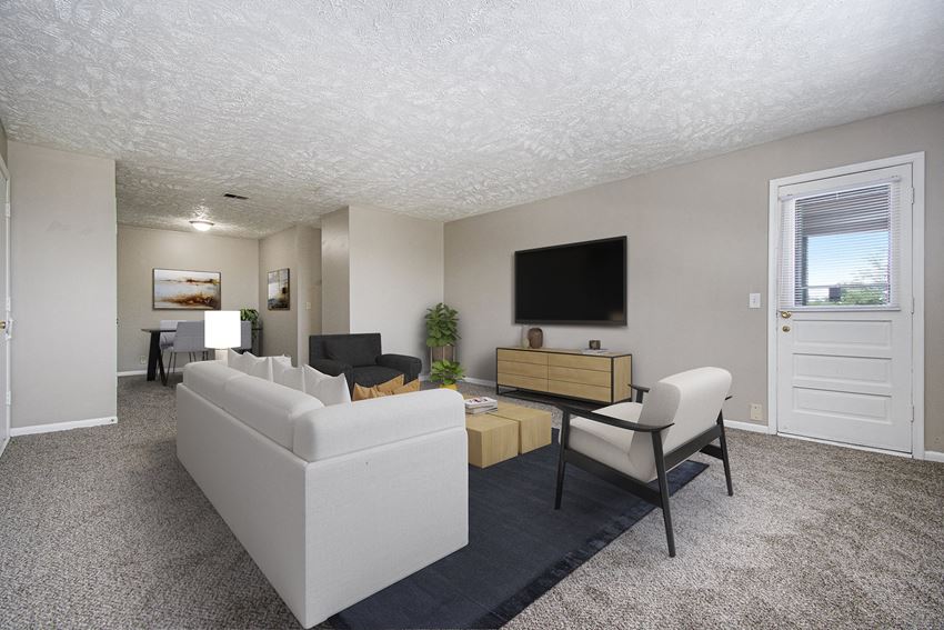 Omaha, NE Maple Ridge Apartments| Living Omaha, NE Maple Ridge Apartments. A living room with white couches and chairs and a tv on the wall