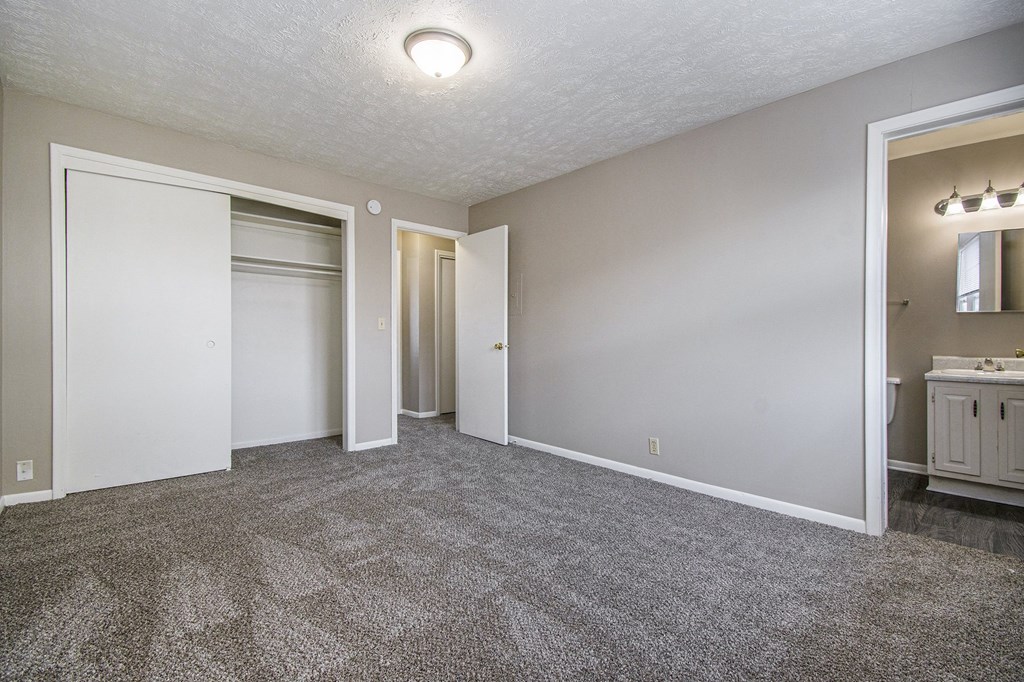 Omaha, NE Maple Ridge Apartments. A bedroom with a bathroom and a closet