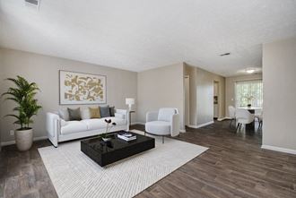 Omaha, NE Maple Ridge Apartment. A living room with a white couch and a coffee table