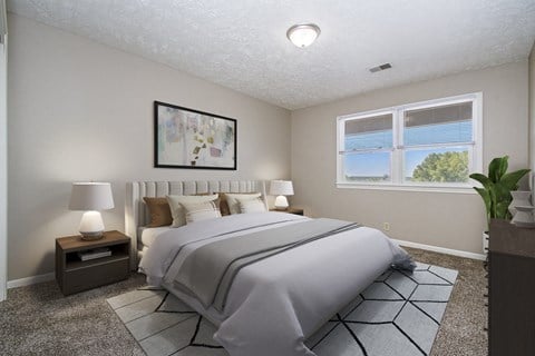 Omaha, NE Maple Ridge Apartments. A bedroom with a large bed and a large window