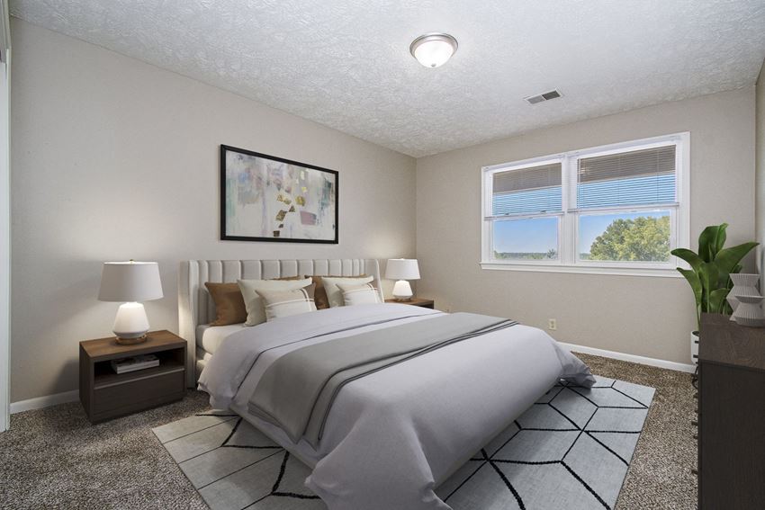 Omaha, NE Maple Ridge Apartments| Bedroom Omaha, NE Maple Ridge Apartments. A bedroom with a large bed and a large window