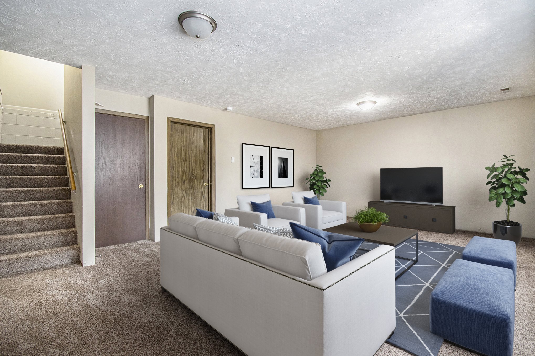 Omaha, NE Stony Brook Townhomes. A living room with couches and a tv