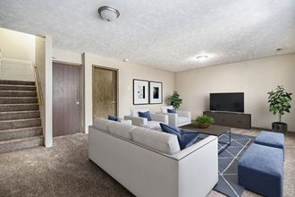 Omaha, NE Stony Brook Townhomes. A living room with couches and a tv
