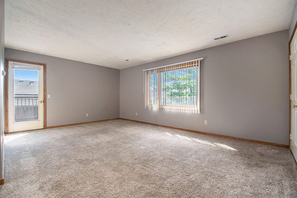 Omaha, NE Woodland Pines Apartments. A living room with a door and a large window