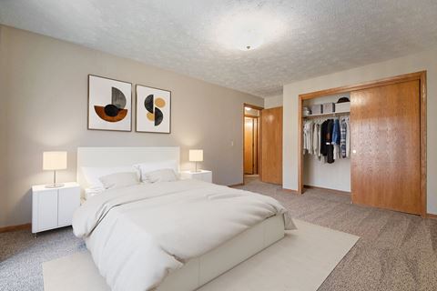 Omaha, NE Woodland Pines Apartments. A bedroom with a bed and a wardrobe