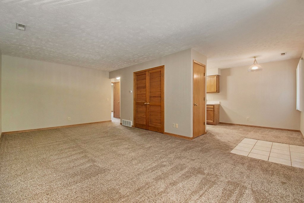 Omaha, NE Woodland Pines Apartments. A living room with a couch and a chair