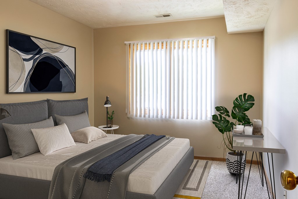 a bedroom with a bed and a window  at Woodland Pines, Omaha, 68134