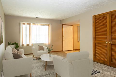 a living room with white furniture and a large window  at Woodland Pines, Omaha, NE