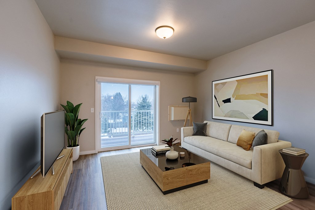 a living room with a couch and a coffee table. Fargo, ND Prairiewood Meadows Apartments