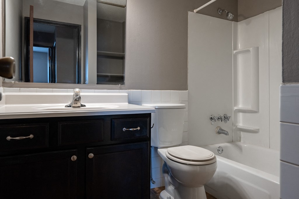 an empty bathroom with a toilet sink and tub. Roseville, MN Rosedale Estates Apartments