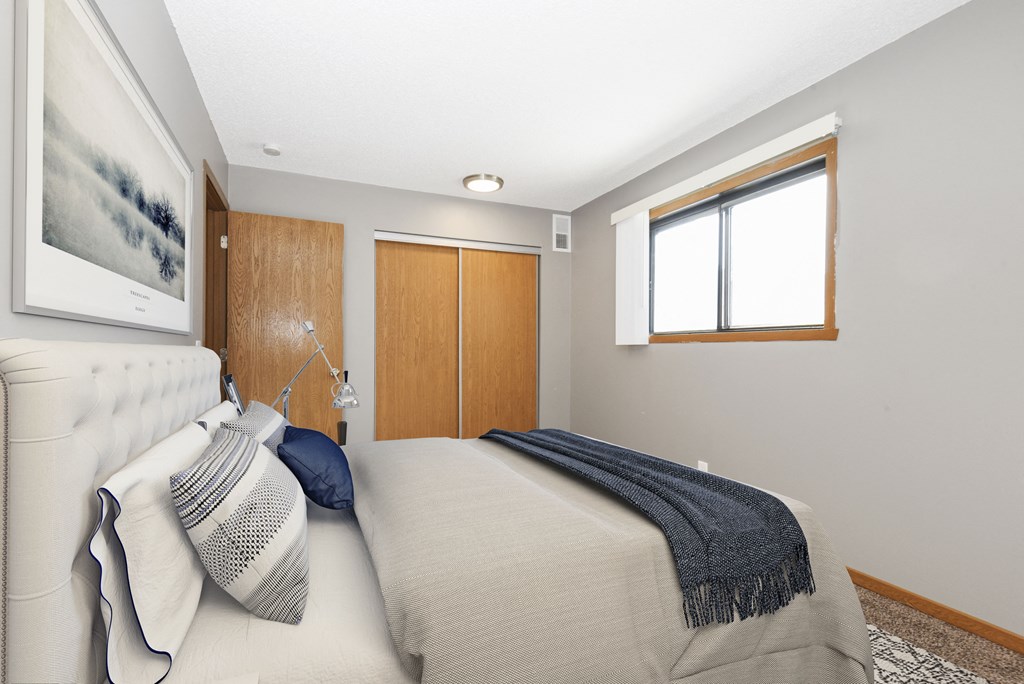 St. Louis Park, MN Courtyard Apartments. A  bedroom in st louis park at courtyard apartments with a bed and a window.