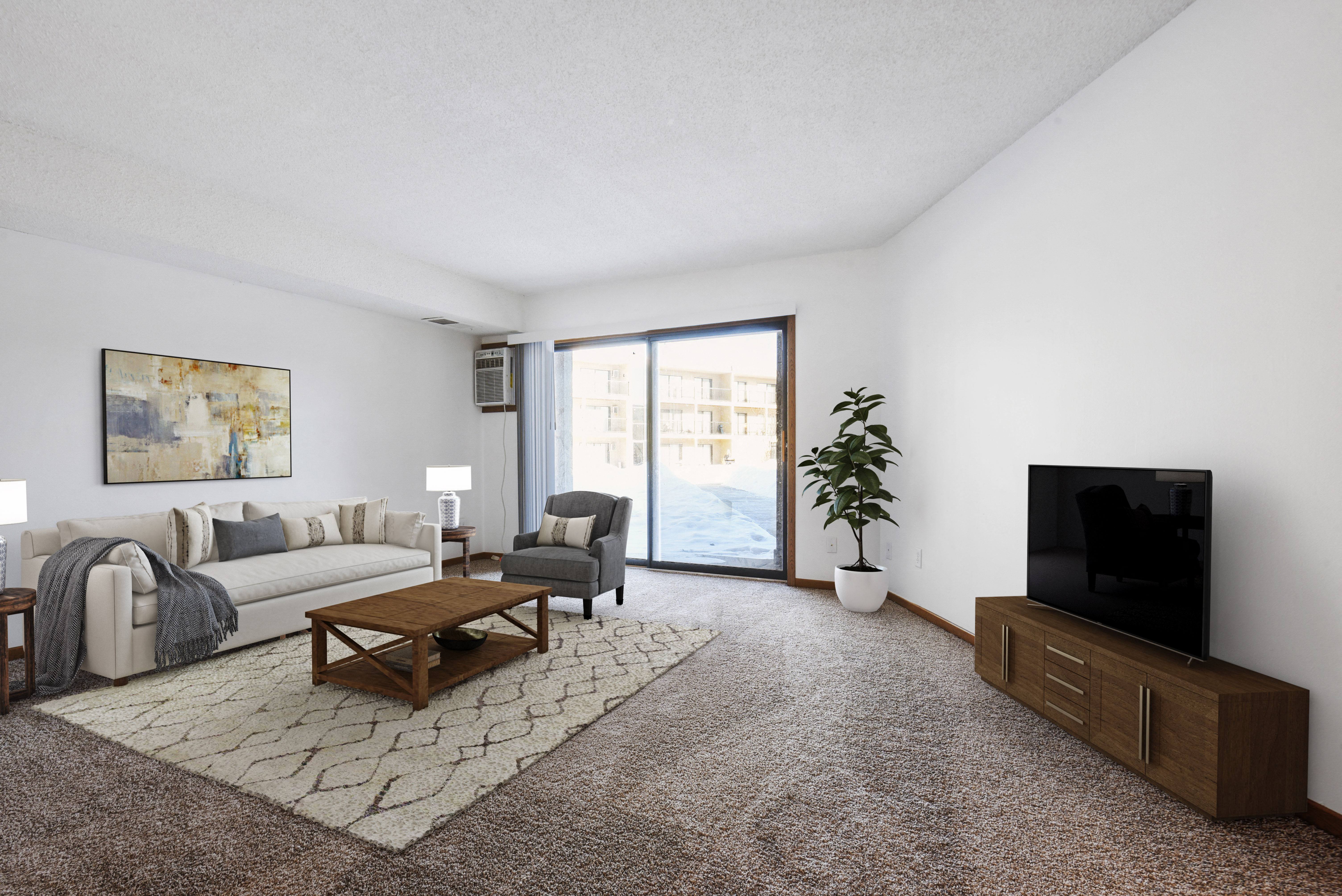 The space is beautifully designed with modern furniture and decor. The living area features a comfortable sofa and stylish coffee table, while the dining area showcases a sleek table and chairs.