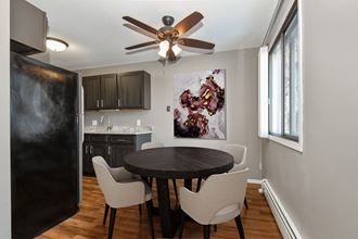 a dining room in st louis park at the edge of uptown with a 4 chair table and a kitchen in the background - Photo Gallery 2