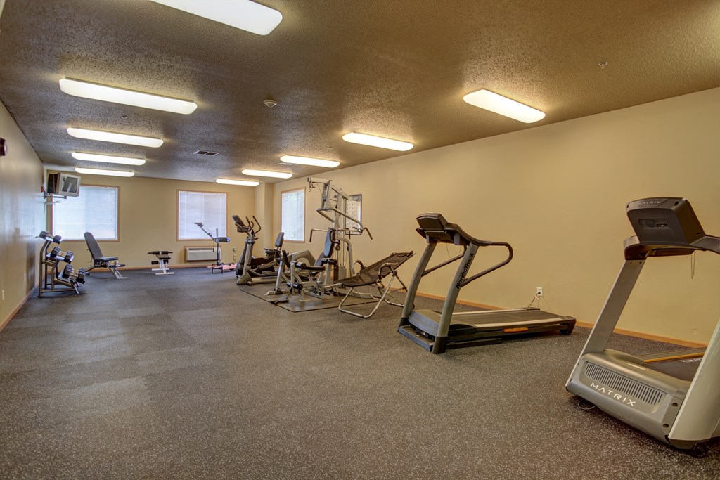 West Fargo, ND West Lake Apartments | Fitness Center A gym with cardio equipment and weights on the floor. West Fargo, ND West Lake Apartments.