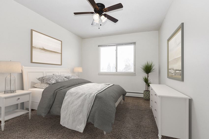 West St. Paul, MN Covington Courts Apartments | Bedroom bedroom in Covington, a residential complex in West St. Paul. The room features a comfortable bed with neatly arranged bedding and minimalist decor. Soft lighting creates a serene and relaxing ambiance, while a large window allows natural light to fill the space. It's a tranquil retreat designed for rest and rejuvenation.