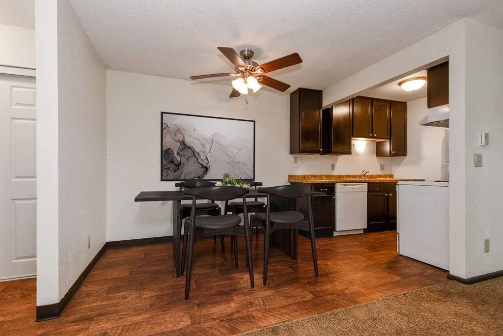 White Bear Lake, MN White Bear Terrace Apartments | Furnished dining room White Bear Lake, MN White Bear Terrace Apartments/. a dining area with a table and chairs and a kitchen in the background
