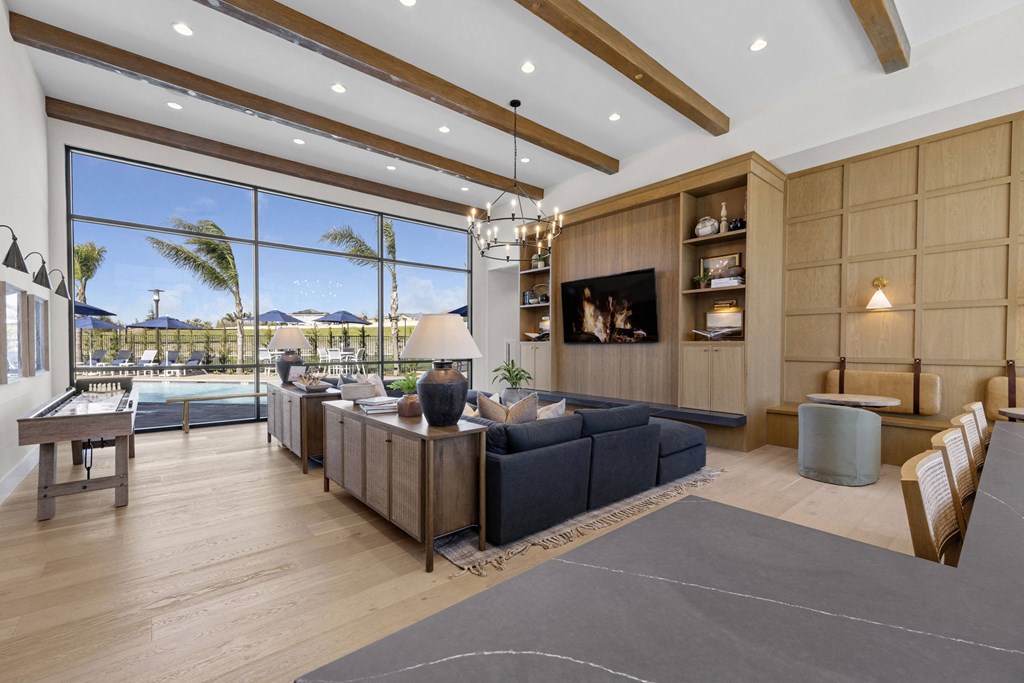 the living room has a large window overlooking the pool and the beachat Westbury Apartments, Rancho Cucamonga, California 