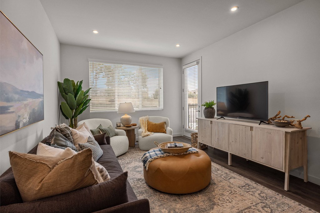 a living room with couches and a tvat Westbury Apartments, California