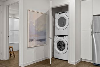 a white washer and dryer in a closet with a doorat Westbury Apartments, Rancho Cucamonga, California 