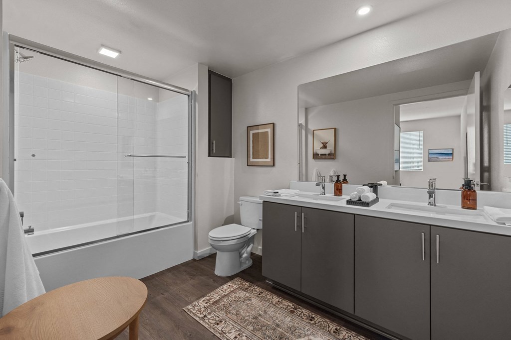 a bathroom with a shower toilet and sink and a mirrorat Westbury Apartments, Rancho Cucamonga, California