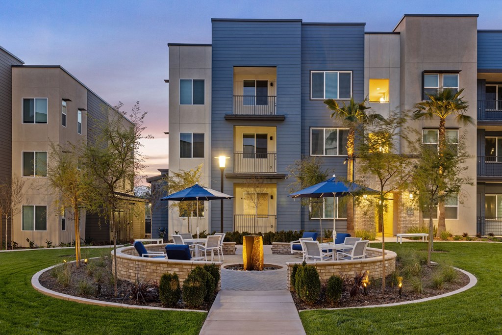 a courtyard with tables and chairs in front of an apartment buildingat Westbury Apartments, Rancho Cucamonga, CA